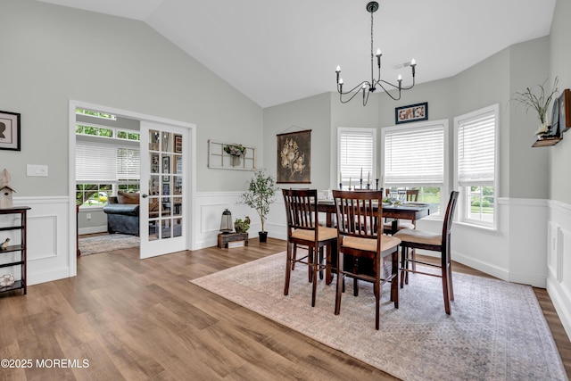 16 Vecchio Rd, Manchester, NJ 08759 - dining space with a wainscoted wall, a chandelier, wood finished floors, vaulted ceiling, and a decorative wall
