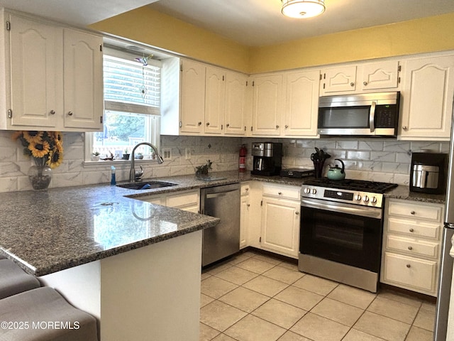 2711 2nd Ave, Toms River, NJ 08753 - kitchen with stainless steel appliances, a peninsula, light tile patterned floors, and white cabinets