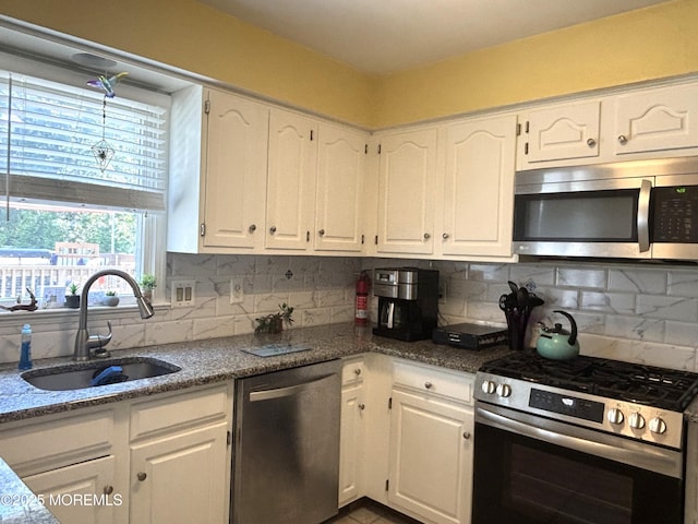2711 2nd Ave, Toms River, NJ 08753 - kitchen featuring appliances with stainless steel finishes, white cabinets, and tasteful backsplash