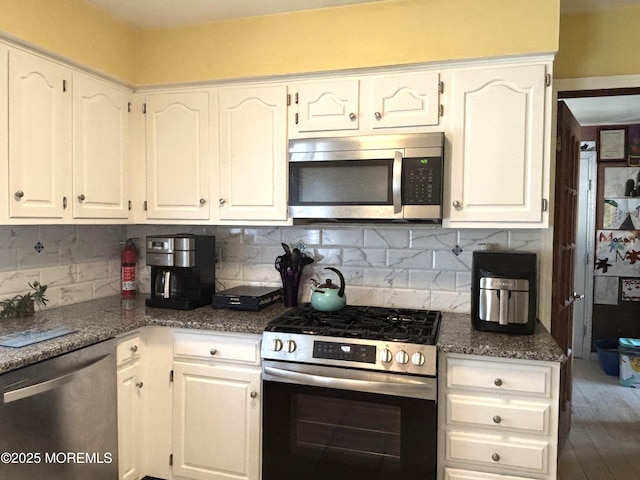 2711 2nd Ave, Toms River, NJ 08753 - kitchen with stainless steel appliances, white cabinets, and decorative backsplash