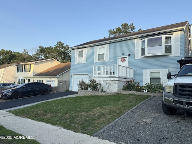 153 Schooner Ave, Barnegat, NJ 08005 - bi-level home featuring a front yard, an attached garage, and driveway