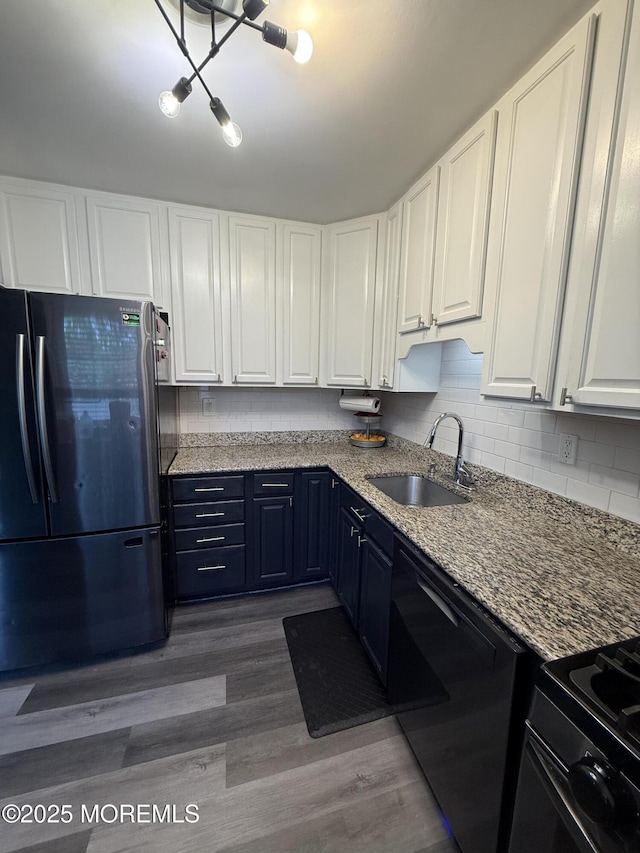 153 Schooner Ave, Barnegat, NJ 08005 - kitchen with freestanding refrigerator, dishwasher, white cabinetry, backsplash, and wood finished floors