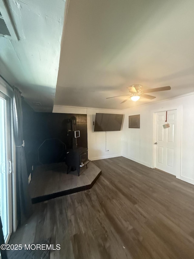 153 Schooner Ave, Barnegat, NJ 08005 - unfurnished living room with a wood stove, wood finished floors, and a ceiling fan