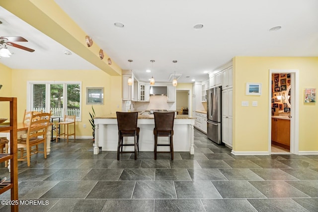 2 Derby Ln, East Brunswick, NJ 08816 - kitchen featuring freestanding refrigerator, a peninsula, ceiling fan, glass insert cabinets, and a kitchen breakfast bar
