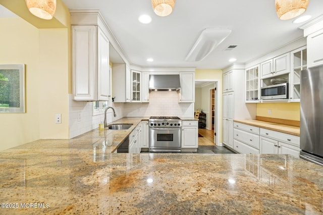 2 Derby Ln, East Brunswick, NJ 08816 - kitchen featuring stainless steel appliances, wall chimney range hood, backsplash, light stone counters, and glass insert cabinets