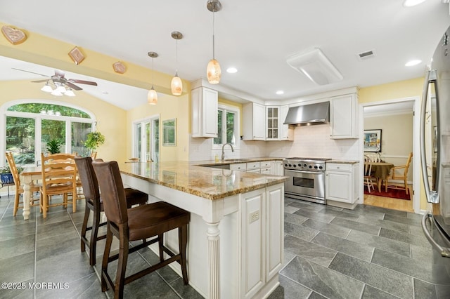 2 Derby Ln, East Brunswick, NJ 08816 - kitchen with stainless steel appliances, wall chimney exhaust hood, a peninsula, healthy amount of natural light, and recessed lighting