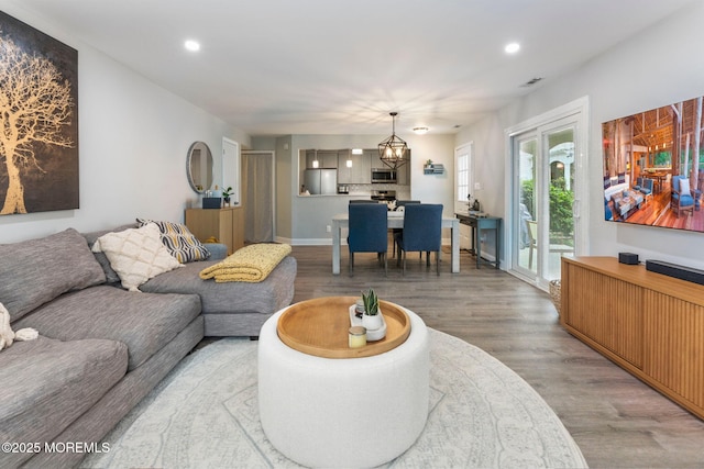 165 Tulip Ln, Freehold, NJ 07728 - living room with light wood finished floors, recessed lighting, and a chandelier