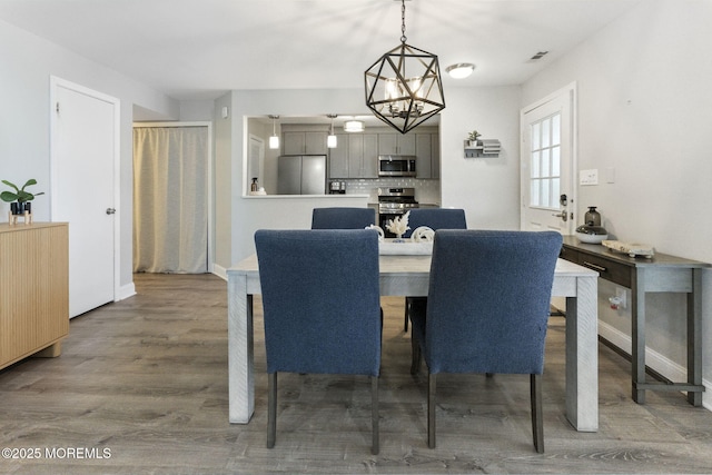 165 Tulip Ln, Freehold, NJ 07728 - dining room featuring wood finished floors and a chandelier