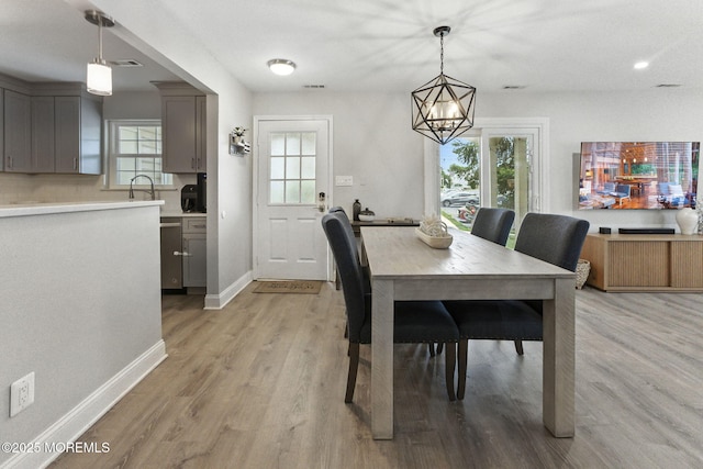 165 Tulip Ln, Freehold, NJ 07728 - dining area with a chandelier and light wood finished floors