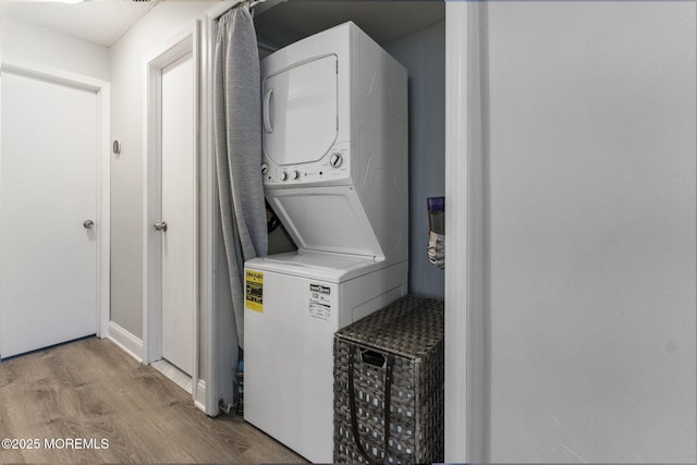 165 Tulip Ln, Freehold, NJ 07728 - washroom with estacked washer and dryer and wood finished floors