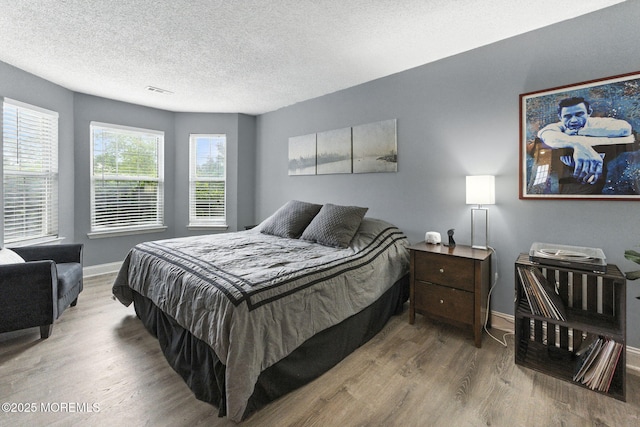 165 Tulip Ln, Freehold, NJ 07728 - bedroom with wood finished floors and a textured ceiling