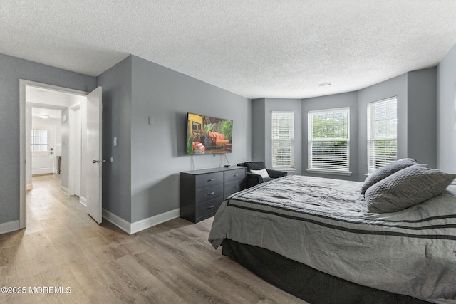 165 Tulip Ln, Freehold, NJ 07728 - bedroom with light wood-style floors and a textured ceiling