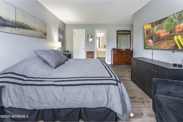 165 Tulip Ln, Freehold, NJ 07728 - bedroom with dark wood-style floors, connected bathroom, and a textured ceiling