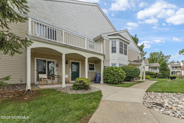 165 Tulip Ln, Freehold, NJ 07728 - exterior space with a balcony, covered porch, and a front yard