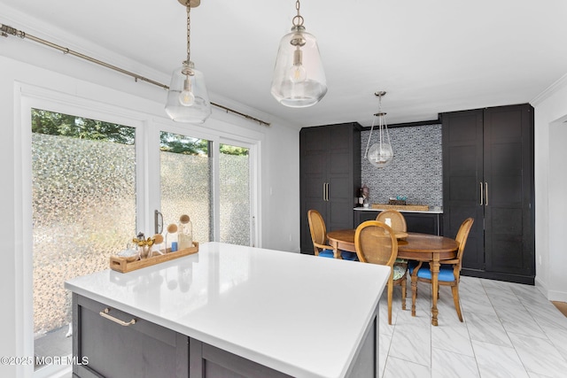 401 Jefferson Dr, East Windsor, NJ 08520 - kitchen featuring light marble finish flooring, light countertops, pendant lighting, crown molding, and a kitchen island