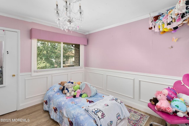 401 Jefferson Dr, East Windsor, NJ 08520 - bedroom with a chandelier, wainscoting, ornamental molding, wood finished floors, and a decorative wall