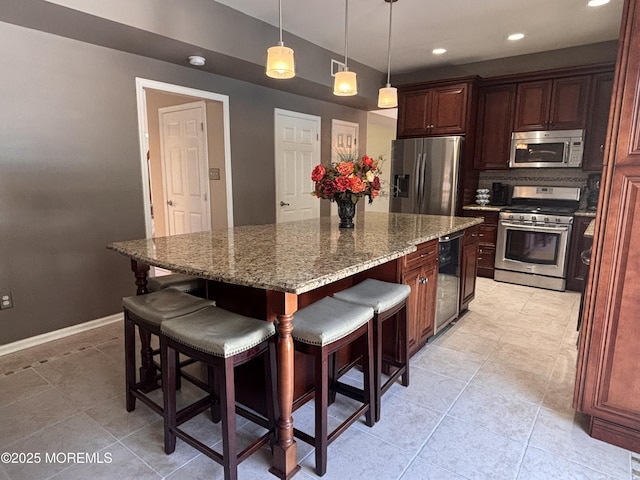 30 Gristmill Rd, Howell, NJ 07731 - kitchen with appliances with stainless steel finishes, a kitchen breakfast bar, a kitchen island, light stone countertops, and recessed lighting