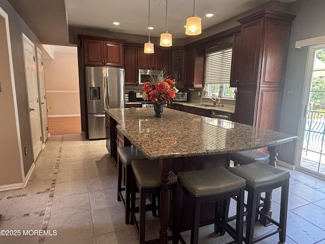 30 Gristmill Rd, Howell, NJ 07731 - kitchen featuring appliances with stainless steel finishes, a kitchen bar, recessed lighting, light stone countertops, and backsplash