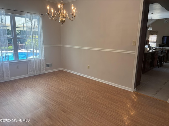 30 Gristmill Rd, Howell, NJ 07731 - unfurnished room featuring wood finished floors, a chandelier, and plenty of natural light