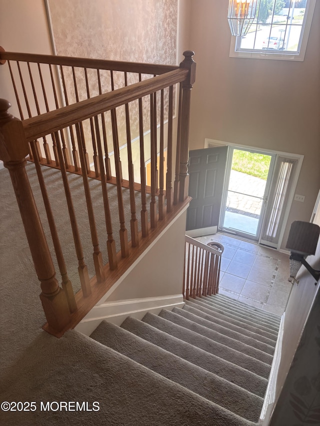 30 Gristmill Rd, Howell, NJ 07731 - stairway with carpet, a chandelier, and a high ceiling