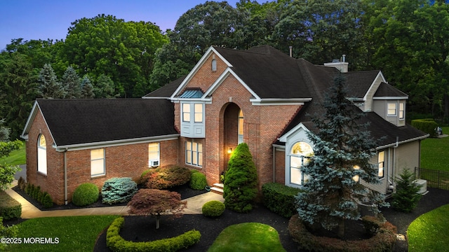 8 Shadowbrook Dr, Colts Neck, NJ 07722 - traditional-style house with brick siding, roof with shingles, and a chimney