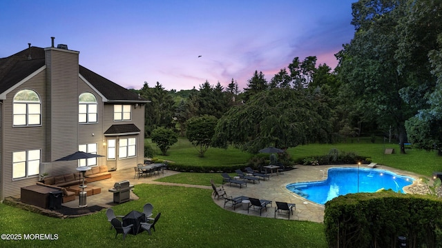 8 Shadowbrook Dr, Colts Neck, NJ 07722 - back of property at dusk featuring a patio area, a lawn, an outdoor pool, and a chimney