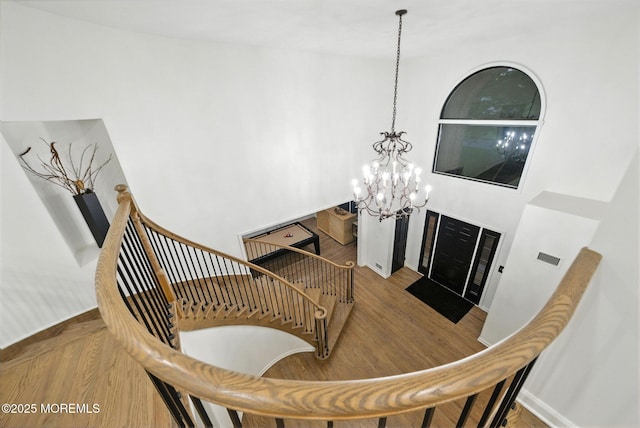 8 Shadowbrook Dr, Colts Neck, NJ 07722 - stairs with a chandelier and wood finished floors