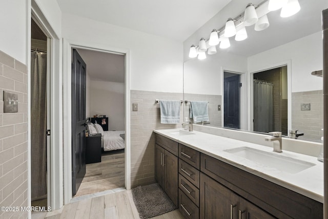 8 Shadowbrook Dr, Colts Neck, NJ 07722 - ensuite bathroom with tile walls, double vanity, wood finished floors, and wainscoting