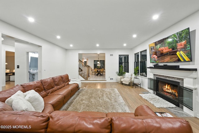8 Shadowbrook Dr, Colts Neck, NJ 07722 - living area with light wood-style floors, recessed lighting, a premium fireplace, and stairway