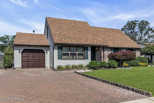 18 Laurel Crest Dr, Howell, NJ 07731 - cape cod home featuring an attached garage, decorative driveway, a front yard, and a shingled roof