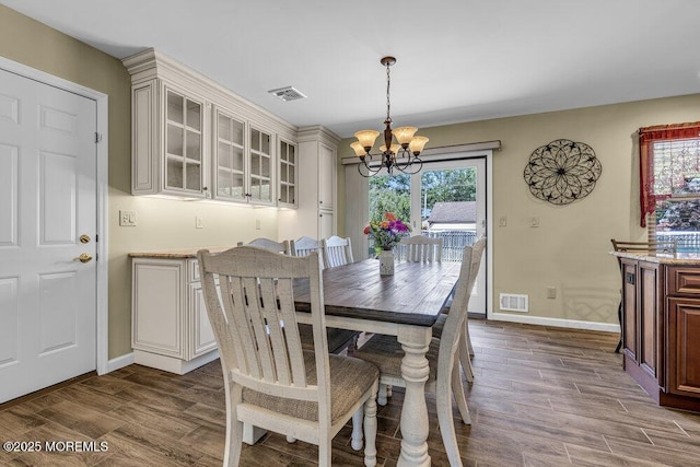 18 Laurel Crest Dr, Howell, NJ 07731 - dining area with a chandelier and dark wood-type flooring