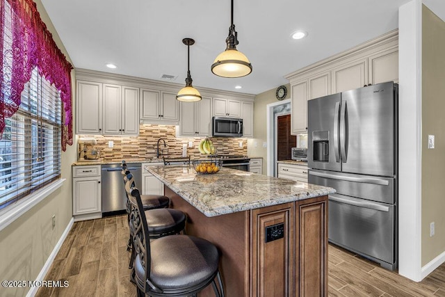 18 Laurel Crest Dr, Howell, NJ 07731 - kitchen with stainless steel appliances, wood finished floors, decorative backsplash, a kitchen island, and recessed lighting