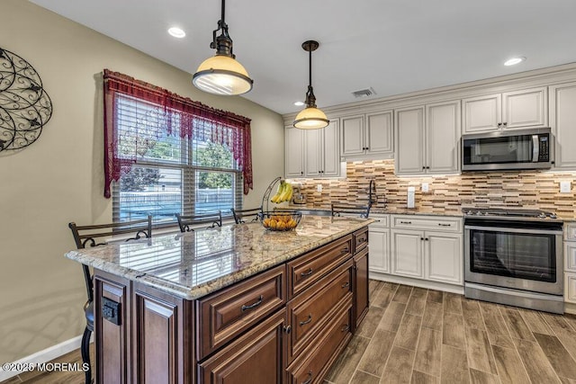 18 Laurel Crest Dr, Howell, NJ 07731 - kitchen with appliances with stainless steel finishes, decorative backsplash, white cabinets, light stone countertops, and dark wood-type flooring