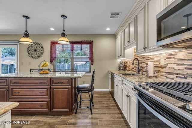 18 Laurel Crest Dr, Howell, NJ 07731 - kitchen featuring stainless steel microwave, recessed lighting, backsplash, wood finish floors, and hanging light fixtures