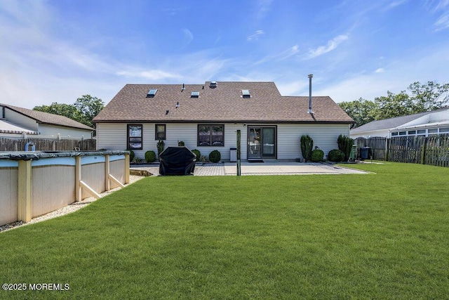 18 Laurel Crest Dr, Howell, NJ 07731 - back of property with a patio and roof with shingles