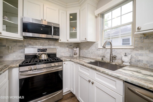 17 Linton Close Close Unit 1000, Freehold, NJ 07728 - kitchen with appliances with stainless steel finishes, white cabinetry, tasteful backsplash, and light stone counters
