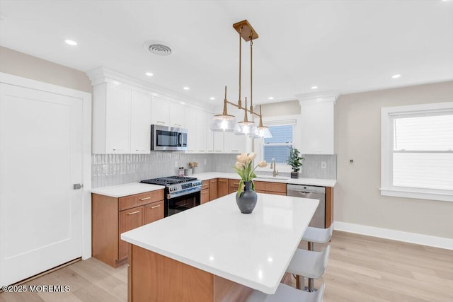 6 Fairfield Rd, Toms River, NJ 08757 - kitchen with stainless steel appliances, light countertops, backsplash, light wood-type flooring, and recessed lighting
