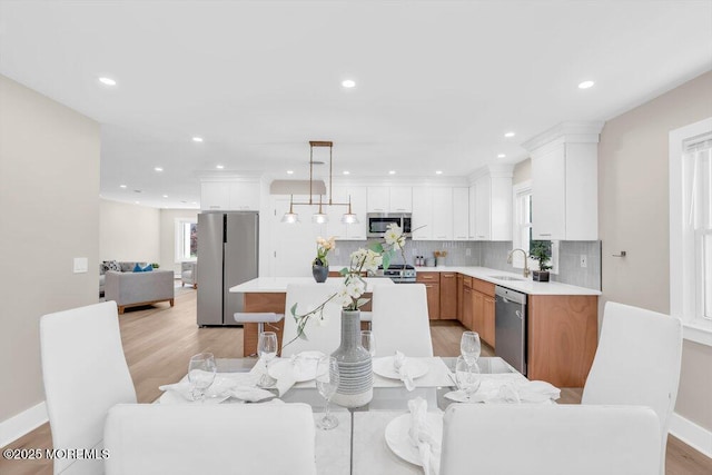 6 Fairfield Rd, Toms River, NJ 08757 - kitchen with appliances with stainless steel finishes, light countertops, open floor plan, decorative backsplash, and white cabinetry