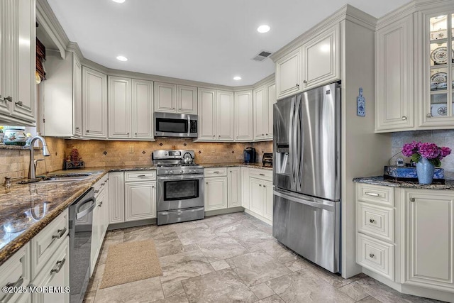 32 Tilton Rd, Brick, NJ 08723 - kitchen with appliances with stainless steel finishes, decorative backsplash, dark stone counters, recessed lighting, and glass insert cabinets