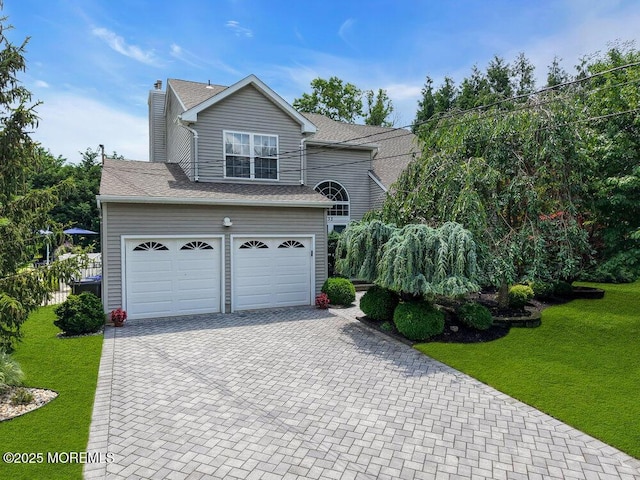32 Tilton Rd, Brick, NJ 08723 - view of front facade with decorative driveway, a garage, a front lawn, and a chimney