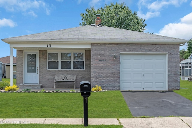 171 Biabou Dr, Toms River, NJ 08757 - view of front of house with a chimney, a front lawn, asphalt driveway, and brick siding