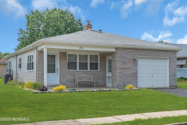 171 Biabou Dr, Toms River, NJ 08757 - view of front of property featuring a chimney, a front lawn, brick siding, and an attached garage
