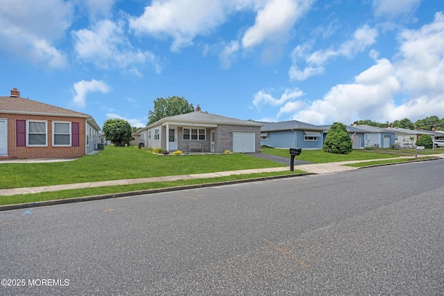 171 Biabou Dr, Toms River, NJ 08757 - view of front facade with asphalt driveway, an attached garage, brick siding, a front lawn, and a residential view