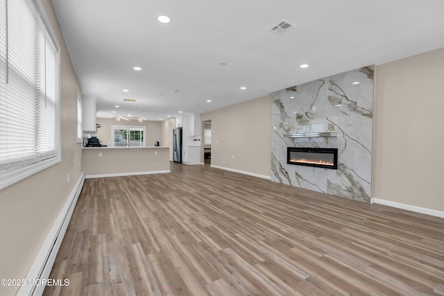 171 Biabou Dr, Toms River, NJ 08757 - unfurnished living room featuring a baseboard radiator, a premium fireplace, recessed lighting, and light wood-style floors