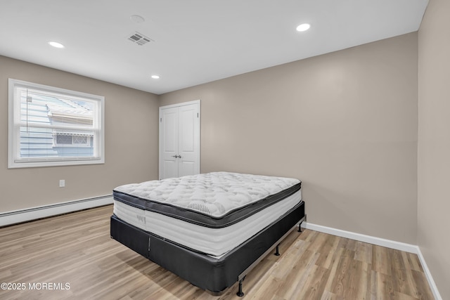 171 Biabou Dr, Toms River, NJ 08757 - bedroom with light wood-style floors, a baseboard heating unit, recessed lighting, and a closet