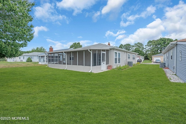 171 Biabou Dr, Toms River, NJ 08757 - rear view of property with a sunroom, a chimney, and a lawn