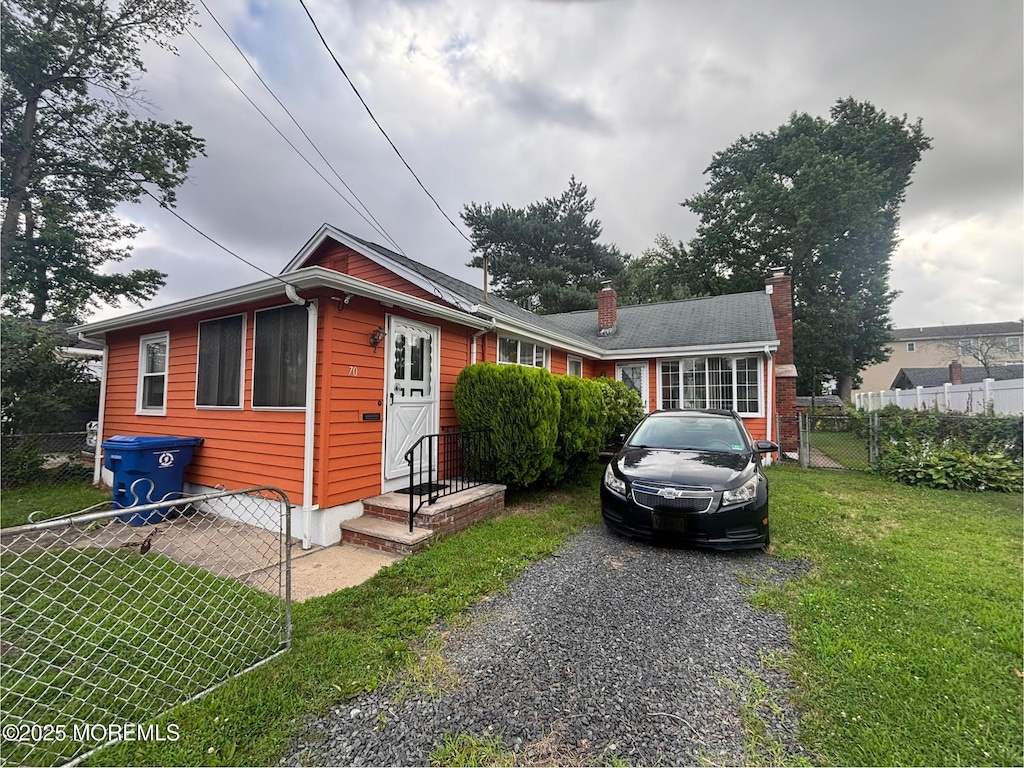 70 Bray Ave, North Middletown, NJ 07748 - view of front facade featuring a gate and a chimney