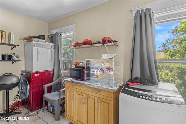 1015 Mattison Ave, Asbury Park, NJ 07712 - laundry area featuring stacked washing machine and dryer and light tile patterned floors