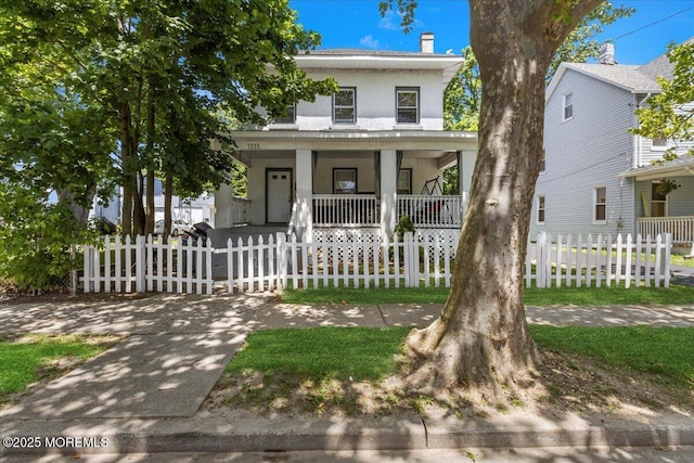 1015 Mattison Ave, Asbury Park, NJ 07712 - american foursquare style home featuring covered porch, stucco siding, and a fenced front yard
