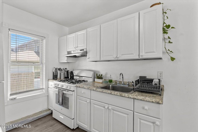 1015 Mattison Ave, Asbury Park, NJ 07712 - kitchen featuring white range with gas stovetop, under cabinet range hood, white cabinets, and wood finished floors